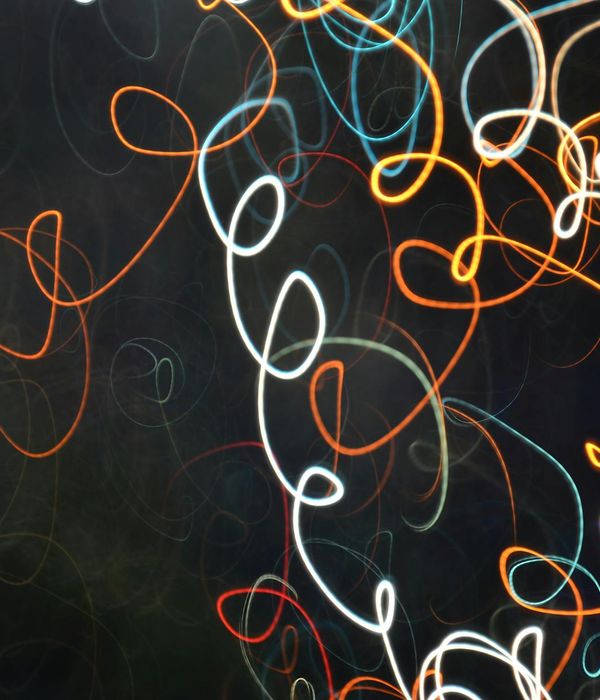 Abstract glowing lines representing feminine inner energy flow